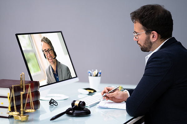 Legal professional holds a conference call. EcoScribe Solutions offers remote depositions in New York and nationwide.