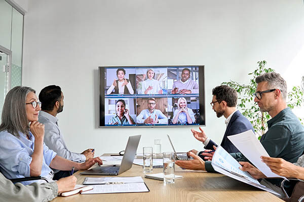 A group of professionals hold a video conference. EcoScribe Solutions offers videotaped deposition services.